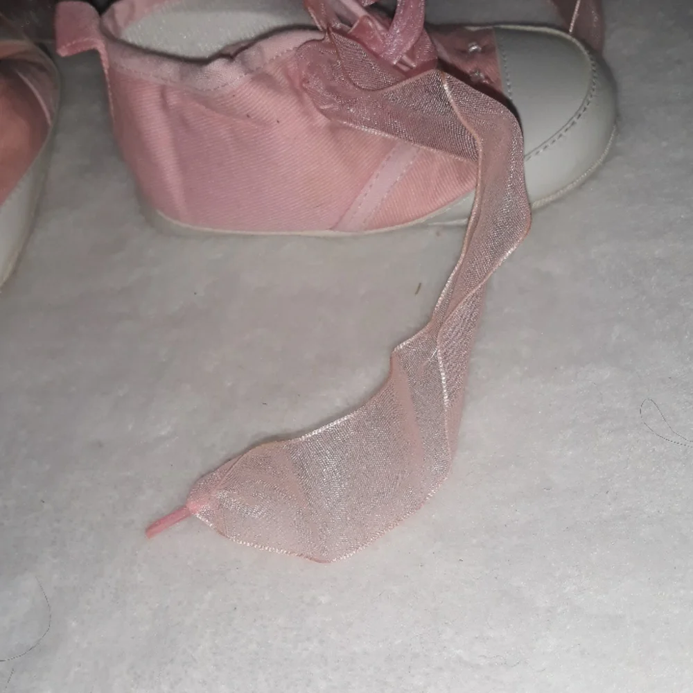 Pink baby sneakers with moon and star beaded accents and fun laces